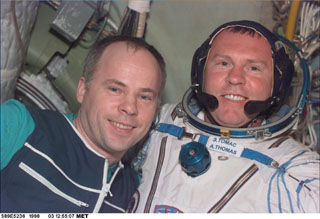 Thomas assisted by Solovyev  with proper fitting and adjustment of the Sokol suit 